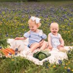 Photo of brother and sister with bunny in flowers