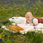 Photo of baby with bunny in flowers