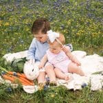 Photo of brother and sister with bunny in flowers