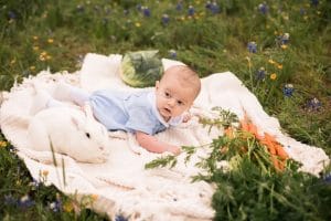 Photo of baby with bunny in flowers